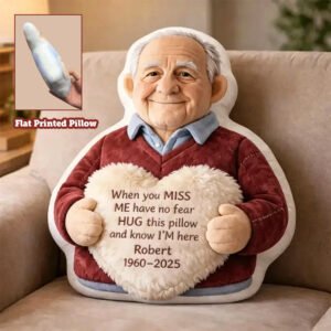 "Custom memorial pillow shaped like an elderly man holding a heart cushion with a personalized message and name, displayed on a sofa with an inset showing the flat printed pillow design