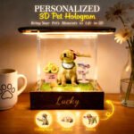 Personalized 3D pet hologram display featuring a dog inside a lit glass box with the name Lucky engraved on the base, showing different pose options like shaking hands, sleeping, and feeding