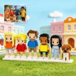Custom brick figures of a family with a dog, inspired by a reference photo, featuring two adults, three children, and one pet displayed in a colorful neighborhood setting