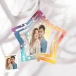 Personalized star-shaped hanging ornament with colorful gradient design featuring a couple’s photo, displayed against a soft fabric background