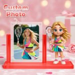 Custom photo figurine display featuring a tennis player image alongside a cartoon-style tennis girl figurine holding a racket, mounted on a red stand with a personalized photo frame