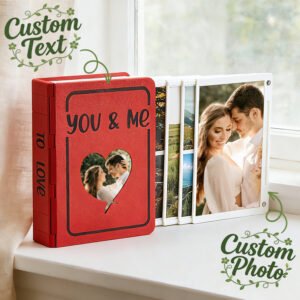 Customizable photo album with a red cover featuring the words 'You & Me' and a heart-shaped cutout. The album includes custom text and photos, showcasing a couple's image on the front page