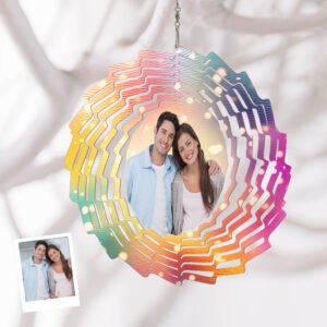 Personalized hanging wind spinner with colorful layered design, featuring a custom couple photo in the center, displayed against a soft fabric background