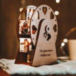 Personalized wooden rotating photo frame with heart cutouts, displaying multiple couple photos in a decorative tabletop design