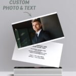 Custom business cards with photo and text, featuring a professional portrait on one side and contact details on the other, displayed in a stacked arrangement