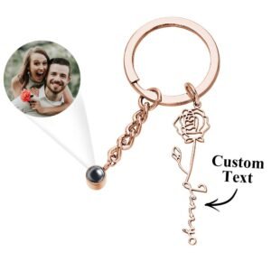 Personalized rose gold keychain with a rose charm, custom name engraving, and a projection photo feature showing a couple’s picture