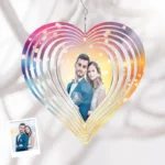 Personalized heart-shaped hanging wind spinner with colorful layered design, featuring a custom couple photo in the center against a soft fabric background